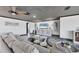 Cozy living room with a ceiling fan, comfortable sectional, and stylish decor at 430 Capri Isles Ct, Punta Gorda, FL 33950
