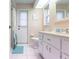 Bathroom featuring double sinks, modern fixtures, and walk-in shower at 4485 Sutlive St, Port Charlotte, FL 33948