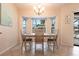 Cozy dining area features a chandelier, a bay window, and a pool view at 4485 Sutlive St, Port Charlotte, FL 33948