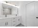 Bright bathroom with double sink vanity, modern lighting and fixtures, and white walls at 4818 Kiska Rd, North Port, FL 34288