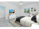 Bedroom features white walls, decor, a television, and a window for natural light at 4818 Kiska Rd, North Port, FL 34288