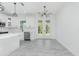 Bright dining area featuring doors that lead to the patio, modern light fixture, and sleek countertops at 4818 Kiska Rd, North Port, FL 34288
