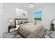 Cozy main bedroom with a large window offering natural light, stylish decor, and a modern chandelier at 4818 Kiska Rd, North Port, FL 34288