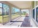 Enjoy outdoor living with a screened-in patio overlooking the green backyard at 565 Mistiflower Cir, Nokomis, FL 34275