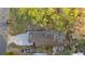 Aerial view showcasing the home, roof, driveway, and surrounding foliage at 6534 29Th N Way, St Petersburg, FL 33702