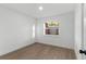 Clean bedroom with wood-look flooring, neutral walls, and a large window at 6534 29Th N Way, St Petersburg, FL 33702