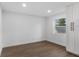 Cozy bedroom featuring wood-look floors, neutral walls, and natural light at 6534 29Th N Way, St Petersburg, FL 33702