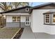 Beautifully updated home with white exterior, gray accents and a manicured front lawn at 6534 29Th N Way, St Petersburg, FL 33702