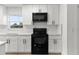 Well-equipped kitchen featuring white cabinets, black appliances and lots of storage at 6534 29Th N Way, St Petersburg, FL 33702