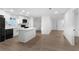 Bright kitchen with white cabinets, black appliances and island with a white countertop at 6534 29Th N Way, St Petersburg, FL 33702