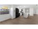 Bright kitchen with white cabinets, black appliances and island with a white countertop at 6534 29Th N Way, St Petersburg, FL 33702
