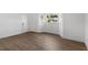 Inviting living room with wood-look flooring, neutral walls, and a large window at 6534 29Th N Way, St Petersburg, FL 33702