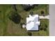 Aerial view of home with white metal roof, lush green lawn, mature landscaping, and beautiful curb appeal at 7534 Carissa, Punta Gorda, FL 33955