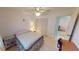 Bedroom with tile floors, ceiling fan, bed, closet, and view into the bathroom at 7534 Carissa, Punta Gorda, FL 33955