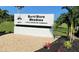 The Burnt Store Meadows community entrance sign is surrounded by lush green landscaping and tropical palm trees at 7534 Carissa, Punta Gorda, FL 33955