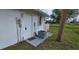 Home exterior featuring door, air conditioning unit, and well-maintained lawn at 7534 Carissa, Punta Gorda, FL 33955