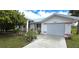 Charming single-story home featuring beautiful lawn, concrete driveway, and white garage door at 7534 Carissa, Punta Gorda, FL 33955