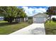 Charming single-story home featuring beautiful lawn, concrete driveway, and white garage door at 7534 Carissa, Punta Gorda, FL 33955