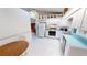 The bright eat-in kitchen has tile flooring and leads into the main kitchen and living room at 7534 Carissa, Punta Gorda, FL 33955