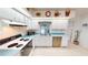 Charming kitchen with white cabinetry, tile flooring, and modern appliances at 7534 Carissa, Punta Gorda, FL 33955
