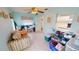Light blue living room with tile floors, a ceiling fan, and some storage containers and a sofa at 7534 Carissa, Punta Gorda, FL 33955