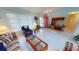 Bright living room with neutral tile floors, comfortable seating, and direct access to the front door at 7534 Carissa, Punta Gorda, FL 33955