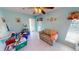 Light blue living room with tile floors, a ceiling fan, a sofa, and some storage containers at 7534 Carissa, Punta Gorda, FL 33955
