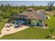 Drone eye view of solar panels, a screened pool, and a manicured lawn at 9149 Lane Ct, Port Charlotte, FL 33981