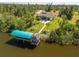 Stunning waterfront home featuring a boat lift, tiki hut and lush landscaping at 9149 Lane Ct, Port Charlotte, FL 33981
