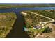 Aerial image featuring a waterfront home with a private boat dock and lush surroundings at 9149 Lane Ct, Port Charlotte, FL 33981