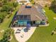 Backyard aerial showing the screened pool, patio, and fire pit area at 9149 Lane Ct, Port Charlotte, FL 33981