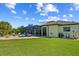 Green backyard with seating and a screen enclosed pool at 9149 Lane Ct, Port Charlotte, FL 33981