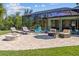 Backyard patio with outdoor seating and lounge chairs by the pool enclosure at 9149 Lane Ct, Port Charlotte, FL 33981