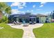 Spacious backyard featuring a patio, outdoor furniture, and lush lawn at 9149 Lane Ct, Port Charlotte, FL 33981