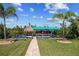 Beautiful landscaping frames the canal view, including boat lift and tiki hut at 9149 Lane Ct, Port Charlotte, FL 33981