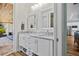 Bright bathroom features a dual sink vanity, plenty of storage, and designer mirrors at 9149 Lane Ct, Port Charlotte, FL 33981
