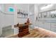 This modern bathroom features a custom vanity, designer mirror, and decorative, stack-wood display table at 9149 Lane Ct, Port Charlotte, FL 33981