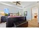 Bedroom featuring a ceiling fan, tray ceiling, and large windows overlooking the landscape at 9149 Lane Ct, Port Charlotte, FL 33981