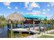 Enjoy waterfront living with this covered boat lift and tiki hut at 9149 Lane Ct, Port Charlotte, FL 33981