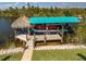 A covered boat lift and tiki hut allow enjoyment of this waterfront retreat at 9149 Lane Ct, Port Charlotte, FL 33981