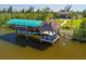 Waterfront property featuring boat lift and tiki hut perfect for entertaining guests at 9149 Lane Ct, Port Charlotte, FL 33981