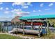 Waterfront property featuring a private boat lift and tiki hut at 9149 Lane Ct, Port Charlotte, FL 33981