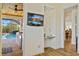 Hallway features a TV and built-in desk perfect for a home office, leading to an outdoor view at 9149 Lane Ct, Port Charlotte, FL 33981