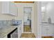 Hallway view showcasing the kitchenette, doorway to a room, and a full bathroom at 9149 Lane Ct, Port Charlotte, FL 33981
