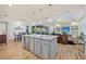 Open kitchen with a large island, stainless steel appliances, and seamless flow into the dining and living areas at 9149 Lane Ct, Port Charlotte, FL 33981