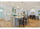 Open-concept kitchen with an island, stainless steel appliances, and seamless flow to the dining area at 9149 Lane Ct, Port Charlotte, FL 33981