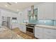 Elegant kitchen showcasing a stainless steel gas range, white cabinets, and blue backsplash at 9149 Lane Ct, Port Charlotte, FL 33981