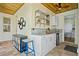 Charming kitchenette featuring marble counters, mini-fridge, wood ceilings, and stylish decor at 9149 Lane Ct, Port Charlotte, FL 33981