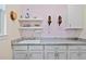 Laundry room featuring white cabinets, marble counters, shelving, and wall-mounted vacuum cleaners at 9149 Lane Ct, Port Charlotte, FL 33981