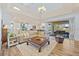 Open-concept living room with wood floors and sliding glass doors to the pool area at 9149 Lane Ct, Port Charlotte, FL 33981